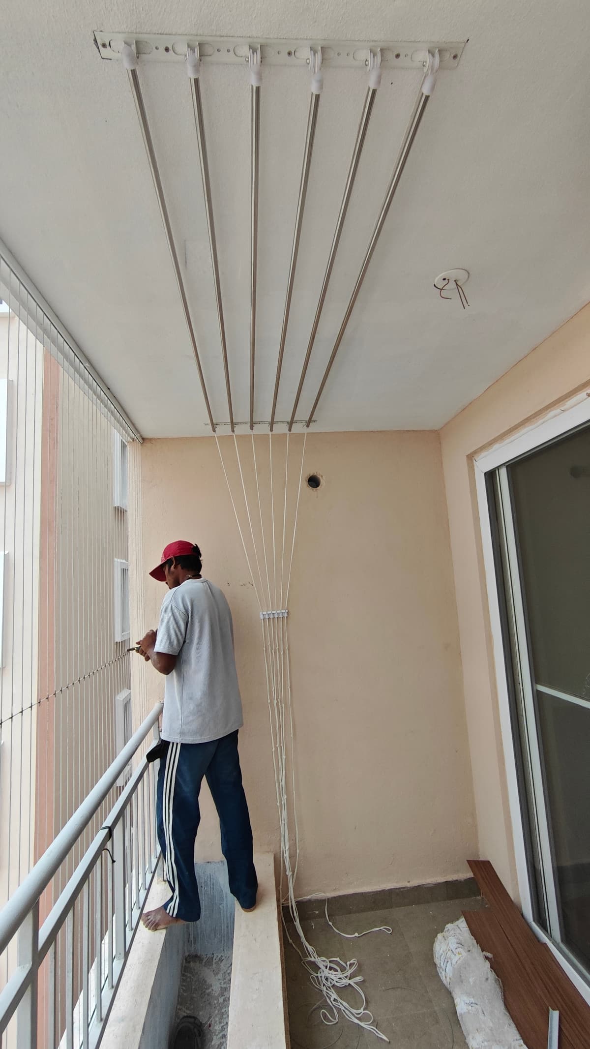 Ram Enterprises - Ceiling Cloth Hangers - Individual rod hoist stainless pulley drying system mounted to utility balcony ceiling.